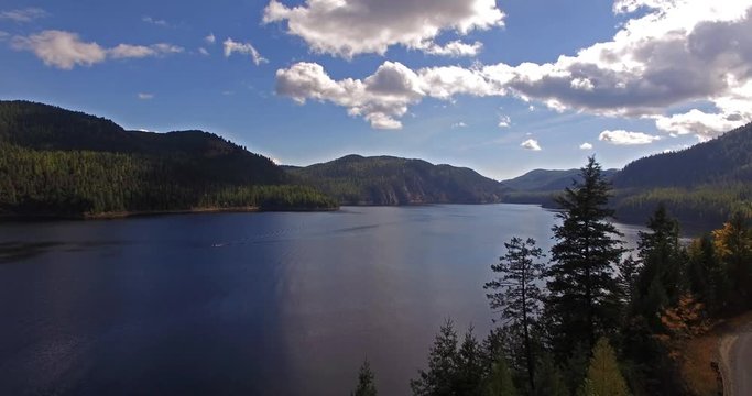 Aerial Drone Shot in Montana on a lake with a boat in the Fall or Autumn