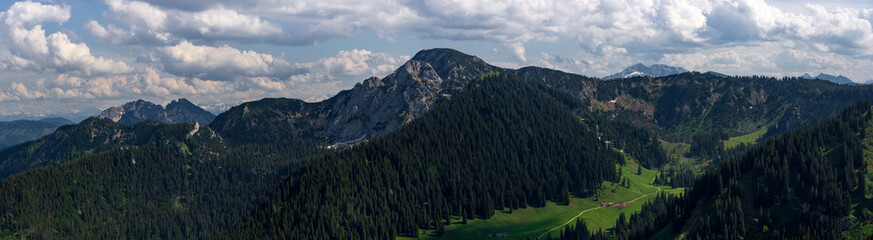 Fototapeta na wymiar Dramatic mountain landscape from top of Wallberg in Germany with green valleys below