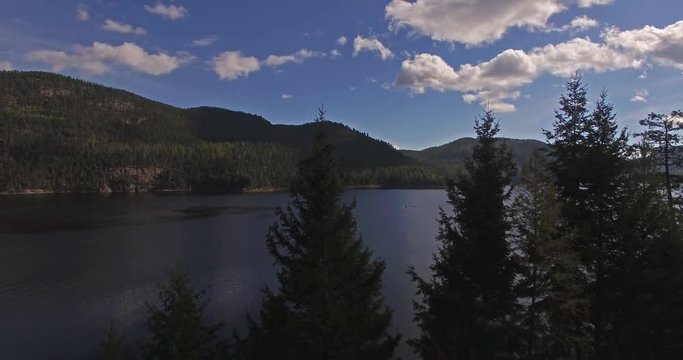 Aerial Drone shots of a Lake in Montana in the Fall or Autumn panning up pine trees