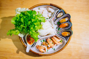 Boiled seafood with prawns and New Zealand mussels is served with Khao Poon and Thai Seafood Sauce Place a beautiful dish in Khantoke.