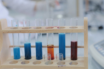 Female Research Scientist Uses Micropipette Filling Test Tubes in a Big Modern Laboratory.