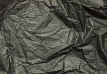 Black crumpled paper abstract background
