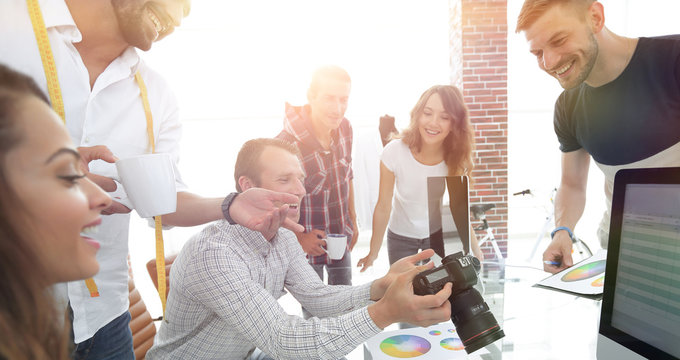 group photo of editors working in a modern office.