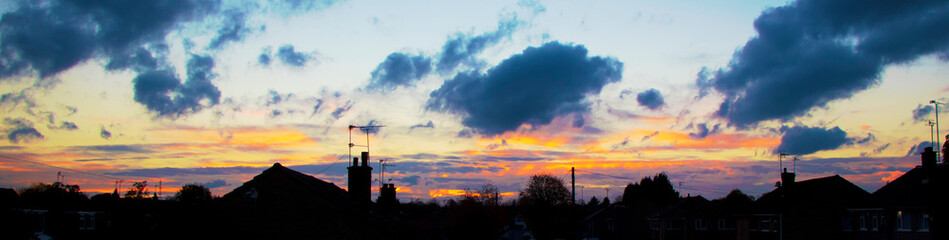 An urban sunset panorama with houses in silhouette