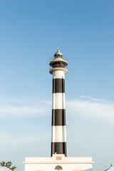 View of the lighthouse of Menorca Cap d Artrutx, with a blue sky in the background. Balearic Islands, Mediterranean Sea.