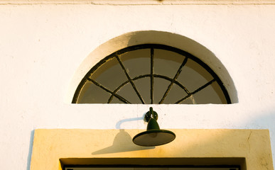 home porch light at the entrance of the Cap de Artrutx lighthouse, on the island of Menorca, Balearic Island, in the Mediterranean, Spain.