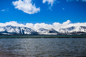Lake Tahoe and the snow covered Sierra mountains on a clear and sunny day; California