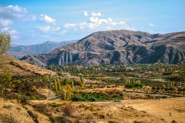 Autumn landscape with yellowed fields and gardens in the Armenian village,located high in the mountains Geghama ridge