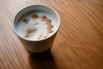Latte on light brown table selective focus shot with space for text