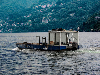 Fototapeta na wymiar transport boat direct on the Lake Como building site.Italy
