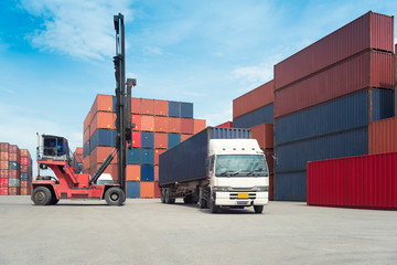 Forklift handling container box loading to freight train in import and export