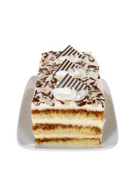 Tiramisu on a rectangular plate isolated on white. A popular Italian dessert with of layers of sponge cake soaked in coffee and brandy or liqueur with powdered chocolate and mascarpone cheese.