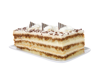 Tiramisu on a rectangular plate isolated on white. A popular Italian dessert with of layers of sponge cake soaked in coffee and brandy or liqueur with powdered chocolate and mascarpone cheese.