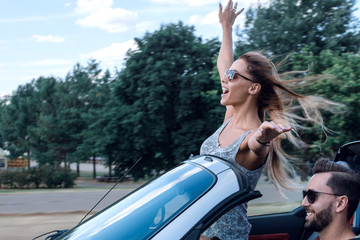 stylish girl enjoying a ride in a convertible car