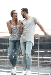 couple of tourists with smartphones standing in the airport term