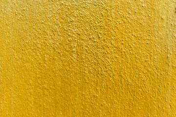 Golden concrete wall scratch Texture. Gold color paint on cement wall background for backdrop design