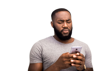 Focused confident adult African American man on a white background in the studio, reads a text...
