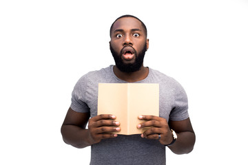 Wow! Is it true? Surprised face of black African American teacher. He reading notebook of his...