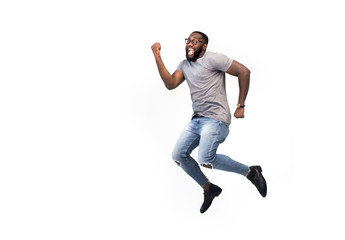 Funny creative black man in fantasy having fun one on white background jump, dance, running to dream, copy space for logo or advertising, African American, success concept, happy worker going to job