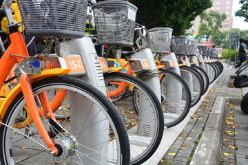 Fototapeta na wymiar city bike, a row of public bicycles for rent parking on footpath in Taipei. Taiwan