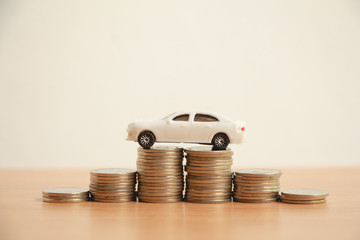 Miniature car on stack of coin money,Financial concept.