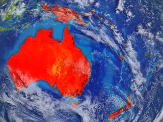 Australia on realistic model of planet Earth with very detailed planet surface and clouds. Continent highlighted in red colour.
