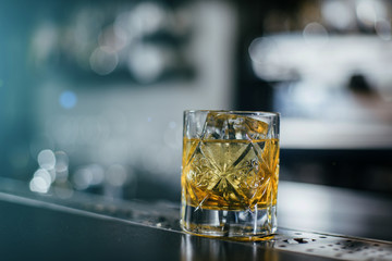 Old Fashioned whiskey coctail, server with oranges close up