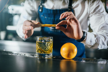 Bartender professionally working with om making drinks and cocktails