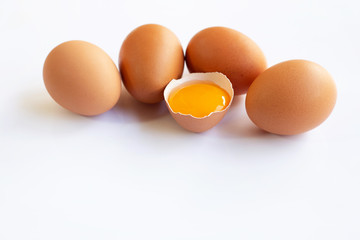 Chicken eggs with yolk on white background.
