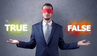 Businessman with red ribbon on his eye deciding true or false