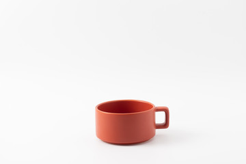 Orange pure bowl for hot soup isolated on white background.