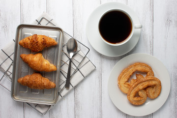 Tasty croissants on wooden background