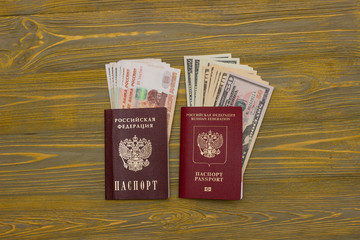 Passport and money on wooden background.