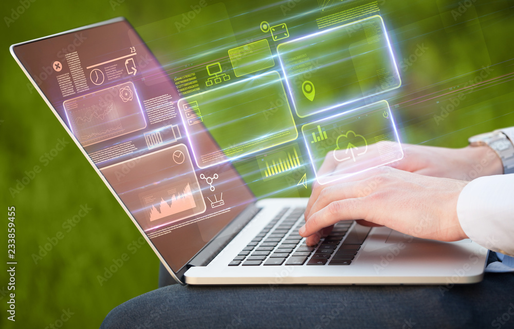 Aufkleber hand using laptop with database reports and online work concept