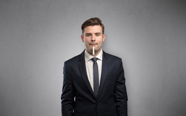 Young tired businessman with thermometer and copy space
