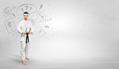 Obraz premium Young kung-fu trainer fighting with doodled symbols concept 