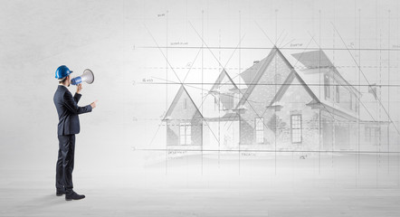 Architect standing and watching an imagined house plan
