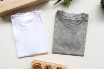 black , gray , white t-shirts with wood box and cactus. rustic background