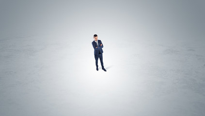 Obraz premium Young businessman standing alone in the middle of an empty space 