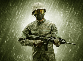 Armed soldier standing in rainy weather
