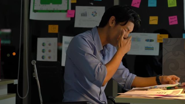 Businessman hard working to late night and work overtime at office. Manager assigns task after timeout of work. Concept of business management, office syndrome and eye problems.
