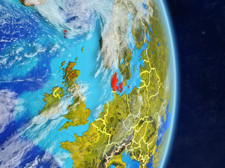 Denmark on planet planet Earth with country borders. Extremely detailed planet surface and clouds.