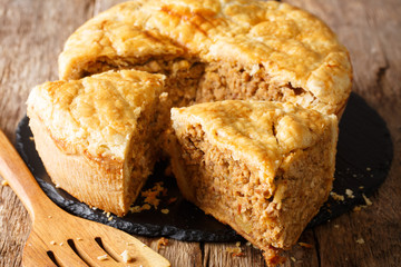 Snack rustic tourtiere pie with pork, mashed potatoes and spices close-up. horizontal