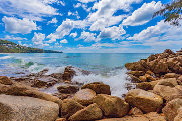 white bubbles from big waves hit on the rock at the end of Naithon beach Phuket