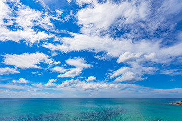 .white cloud  in blue sky above the ocean..