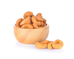 Roasted cashews in bowl wooden on a white background