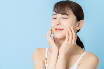 Fototapeta premium attractive asian woman beauty image on blue background