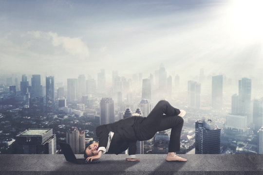 Asian businesswoman with laptop and ballet shoes