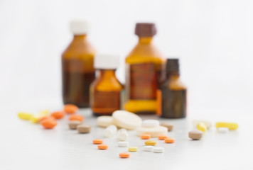 Composition of medicine bottles and pills  on white background