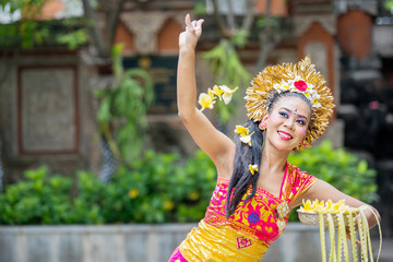 Balinese dancer throwing frangipani flowers
